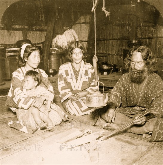 Interior of an Ainu home, showing owner and family, Yezo, Japan 1906