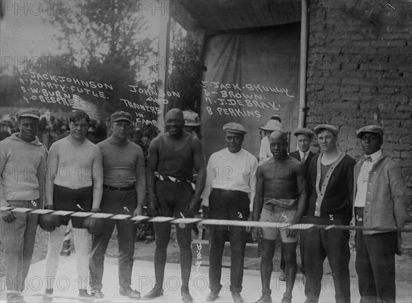 Jack Johnson & trainer in camp- Marty Cutle, W. Burns, C. Respress, Jack Skully, J. DeBray, Perkins 1912