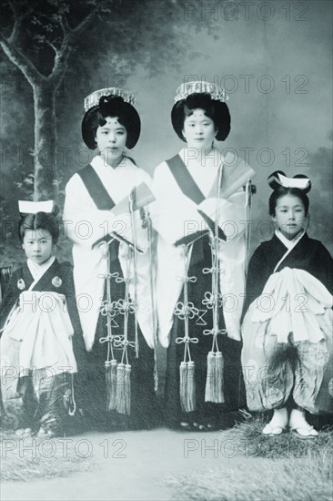 Japanese Mothers with Their Children wear traditional Kimono with Obi & hair combs