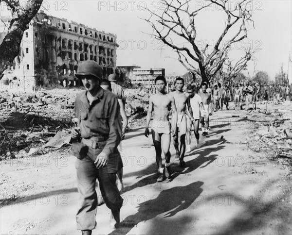 Japanese prisoners of war being guarded by Americans 1944