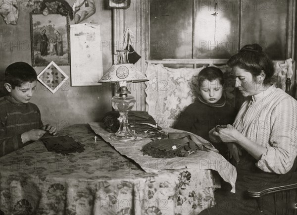 Sewing tapes on Gloves piecework in tenement apartment 1908