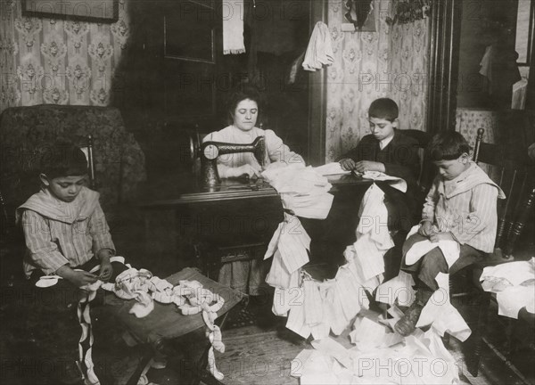 Making dresses for Campbell Kid Dolls in a dirty tenement room 1912