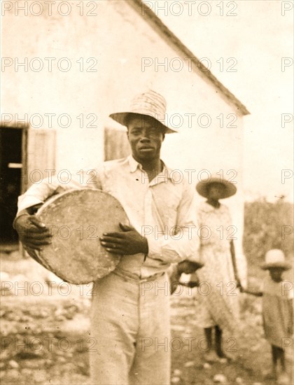 Man posing holding a drum, Cat Island 1935