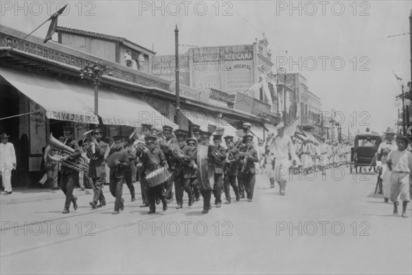 Mexican Band Plays Instruments in front of Marching Columns of US Navy Sailors