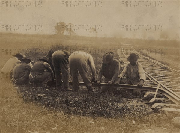 Military railroad operations in northern Virginia: African American laborers twisting rail 1863