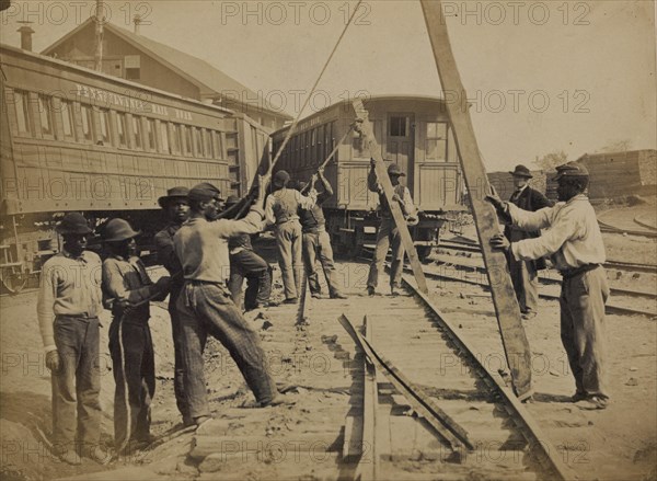 Military railroad operations in northern Virginia: men using levers for loosening rails 1863