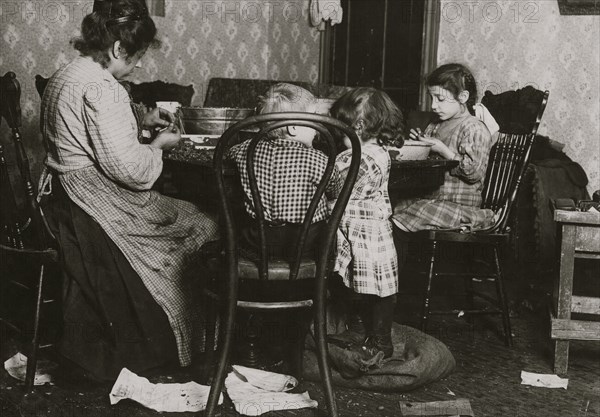 Italian Family picks nuts in their tenement apartment 1911