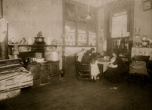 Italian Family picks nuts in their tenement apartment 1911