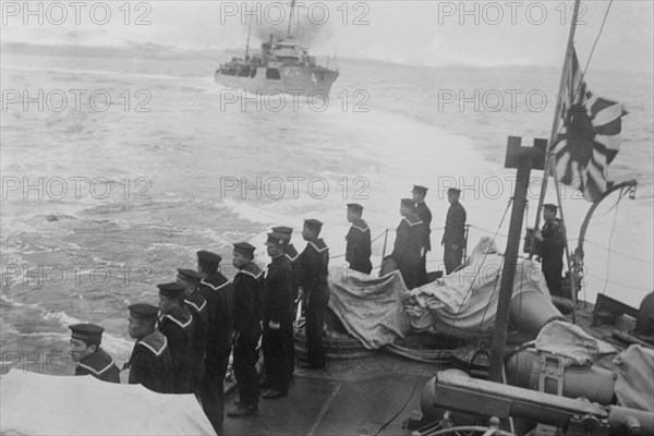 Naval Crew on Japanese Vessel Salutes another and flies the Admiralty Flag