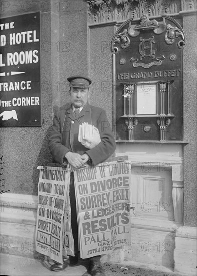 Newspaper salesman in front of Buffet Restaurant in Central London advertises News Headlines