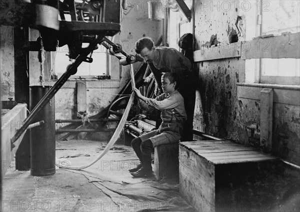 Boy at warping machine. 1908