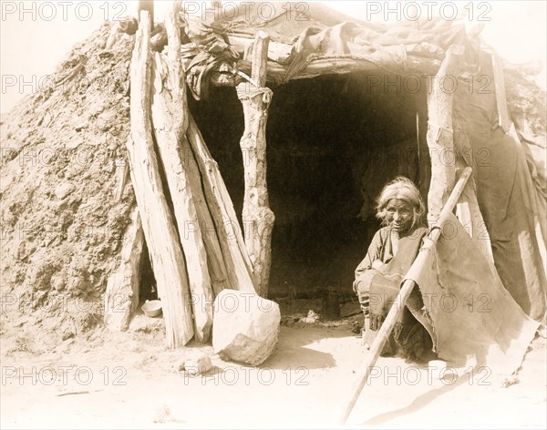 Old Navajo Indian seated in doorway of hogan 1901