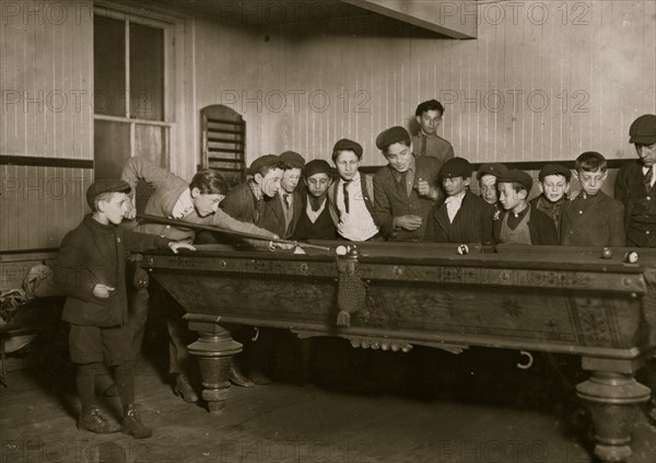 One way to control the street boys. A common scene in the Bancroft-Foote Boys Club, Playing Pool 1909