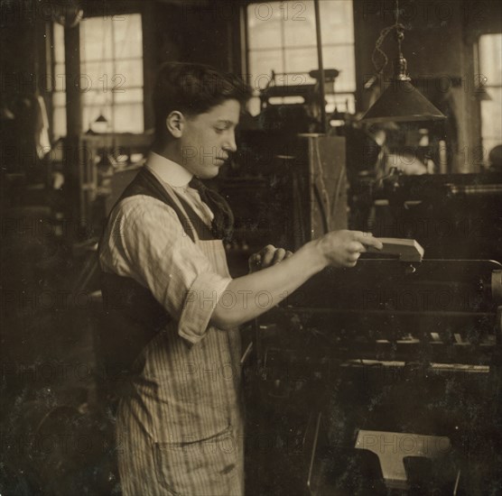 Operating an automatic press. Boston Index Card Co., 113 Purchase Street. 1917