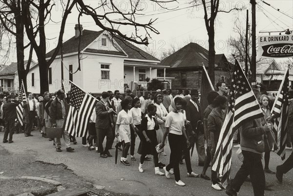 Participants, some carrying American flags, marching in the civil rights march from Selma to Montgomery, Alabama in 1965 1965