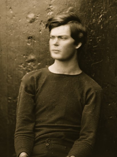 Washington Navy Yard, District of Columbia. Lewis Payne in sweater, seated and manacled 1865