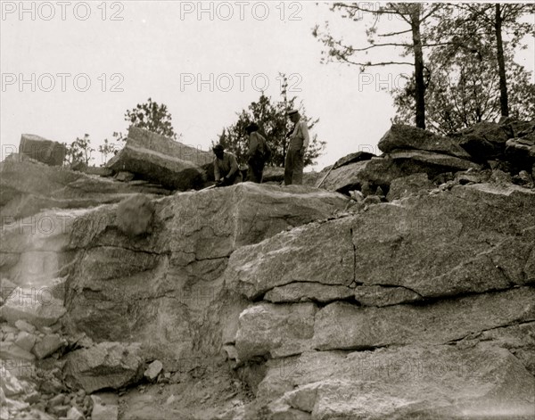 Prisoners breaking up rocks at a prison camp or road construction site 1940