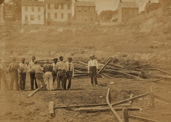 Railroad construction workers straightening track 1863