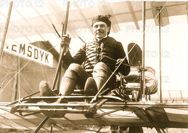 Michael Effimoff seated in flying costume in a primitive plane 1910