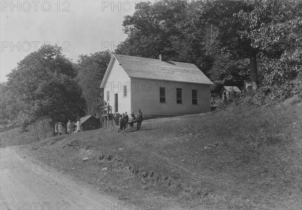 Schools are snuggled up into hillside as this one is - and the road usually runs very near the building. Sunset School, Pocahontas Co. W. Va. Frequently there is little or no level place for a playground. Bad location for toilets, - above the school and near together. 1921