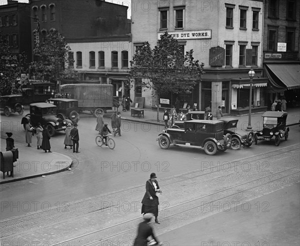 Street Corner in Washington DC in front of dye works with trucks park and growing traffic 1924