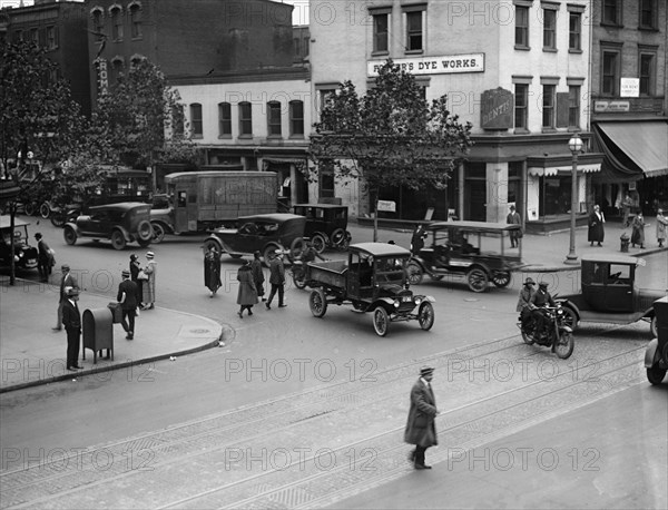 Street Corner in Washington DC in front of dye works with trucks park and growing traffic 1924