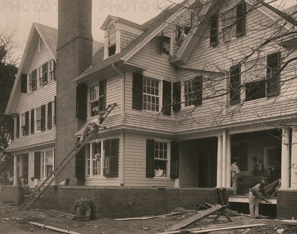 Students at work on a house built largely by them 1899