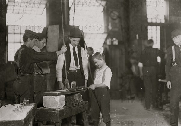 Teaching how to blow mold glass. 1908