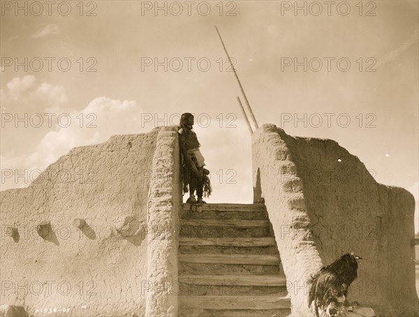 Tewa Indian guard at top of the kiva stairs, San Ildefonso, New Mexico 1905