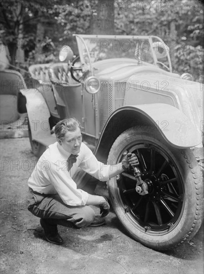 Thomas holds a wrench on the tire center nut