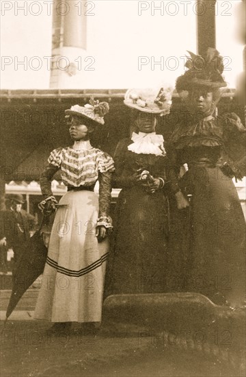 Three African American women, full-length portrait, standing, at the State Fair at Saint Paul, Minn. 1903