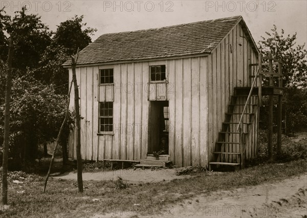 Three families live in this shack: one room above and one below. Bottomley's farm near Baltimore, MD 1909