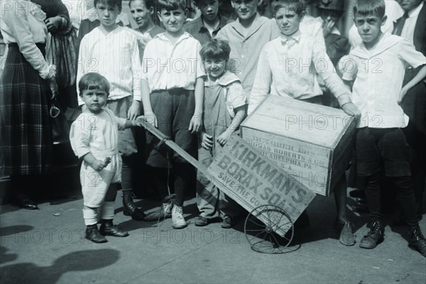 Toddler holds a small Soap Box Derby Vehicle