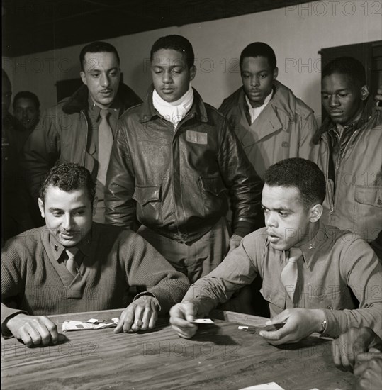 Tuskegee airmen playing cards in the officers' club in the evening 1945