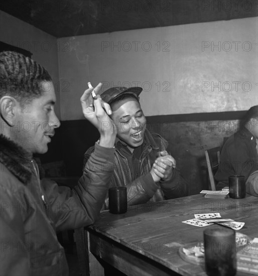 Tuskegee airmen playing cards in the officers' club in the evening 1945