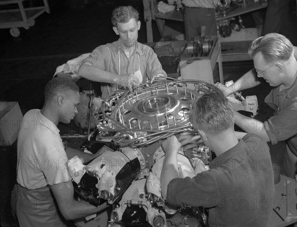 African American works with White employees in Aircraft Production Factory 1942