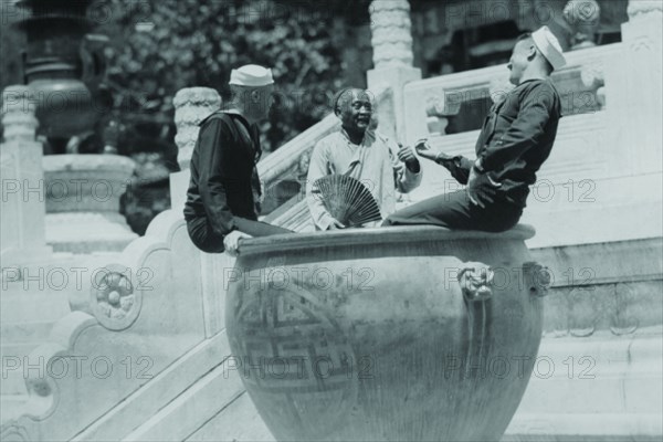 US Navy Sailors on Shore Leave in Beijing frolic in Giant Ceramic Pot with Guide