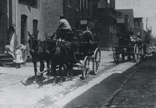 Waiting for the human cargo to start for the Maryland berry fields. Taken on Fells Point, Baltimore 1915