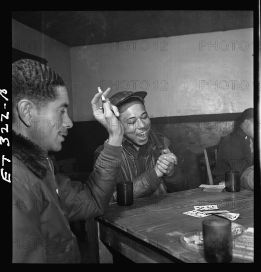 Tuskegee airmen playing cards in the officers' club in the evening 1945