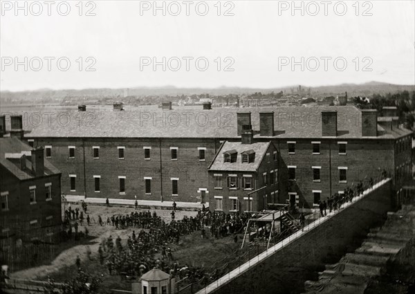 Washington, D.C. Execution of the conspirators: scaffold in use and crowd in the yard, seen from the roof of the Arsenal 1865