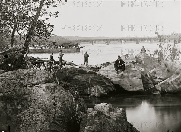 Washington, D.C. Georgetown ferry-boat carrying wagons, and Aqueduct Bridge beyond, from rocks on Mason's Island 1863