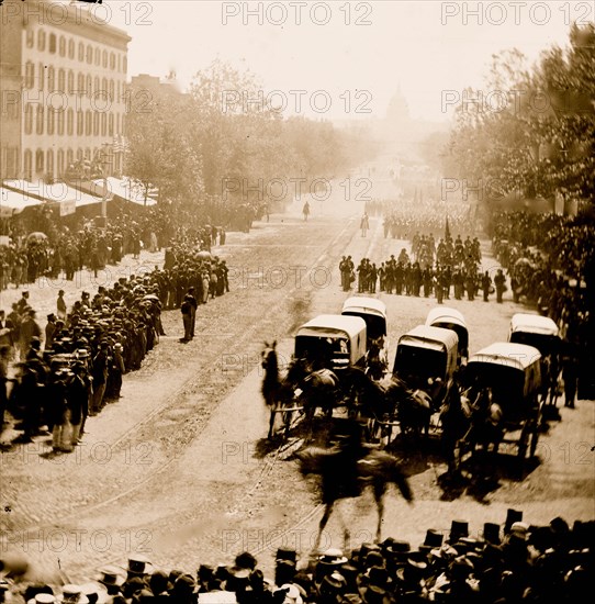 Washington, D.C. Group of ambulances followed by band and infantry units on Pennsylvania Avenue near the Treasury 1865