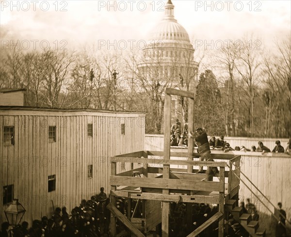 Washington, D.C. Soldier springing the trap; men in trees and Capitol dome beyond 1865