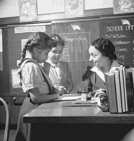 Washington, D.C. Teacher helping pupils in Black grammar school 1942