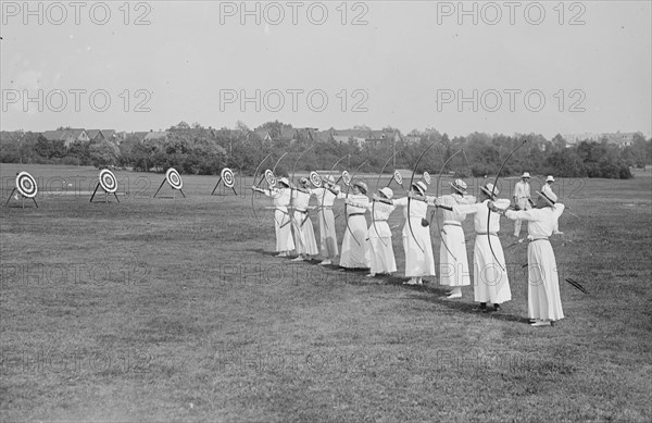 Woman's Archery Team Fires Arrows at a line of targets