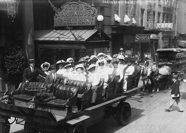 Women in Open Carriage Outside of Fancy Hotel & Restaurant