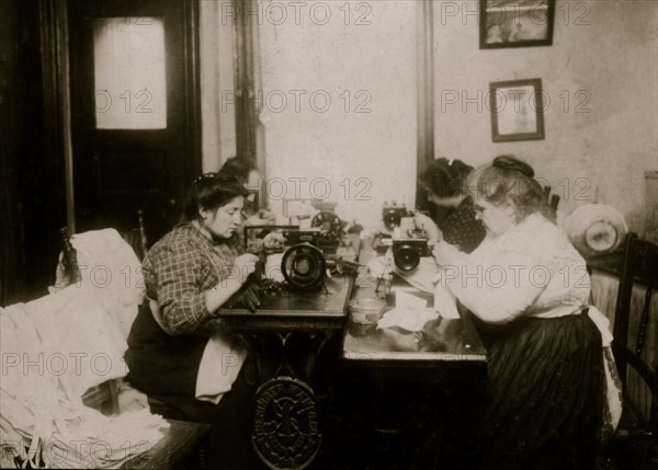 Workers on gloves, crowded into a small kitchen. Dallavalla, 50 McDougal St. 1912