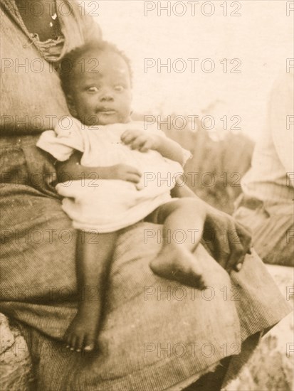 Young baby held by mother, Old Bight, Cat Island, Bahamas 1935