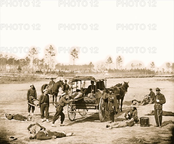 Zouave ambulance crew demonstrating removal of wounded soldiers from the field 1863