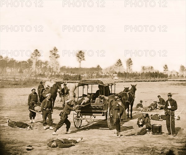 Zouave ambulance crew demonstrating removal of wounded soldiers from the field 1863